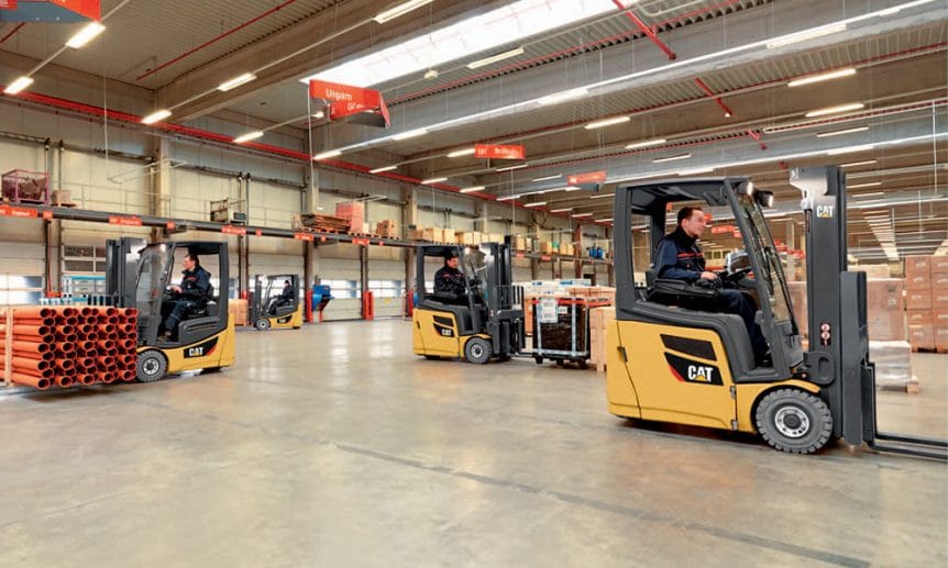 Three Cat Forklifts in a warehouse