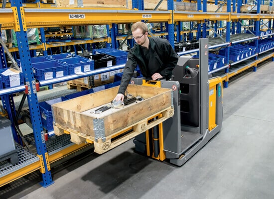 Small Parts Order Picker in Warehouse Aisle