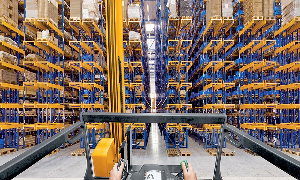 VNA forklift about to drive into pallet rack row