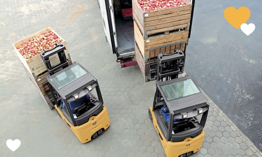 Overhead shot of two Cat forklifts carrying apples