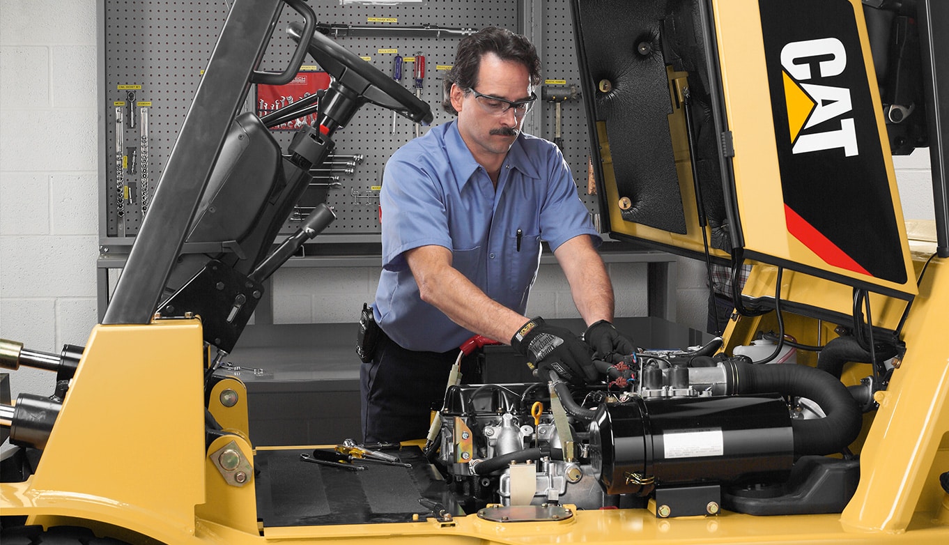 Forklift Service Tech working on a Cat Forklift