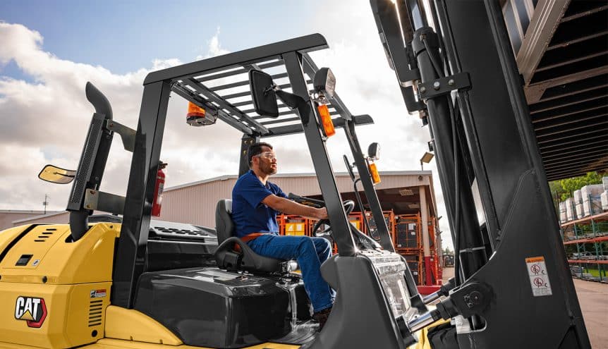 Man outside on a pneumatic forklift