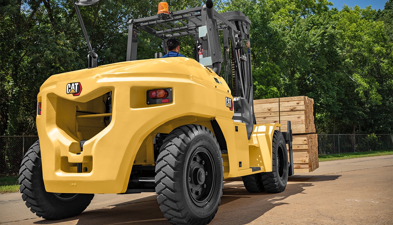 Heavy duty forklift carrying a load of lumber